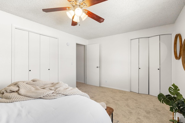 8305 W Rifleman St, Boise, ID 83704 - bedroom featuring light carpet, two closets, a textured ceiling, and a ceiling fan