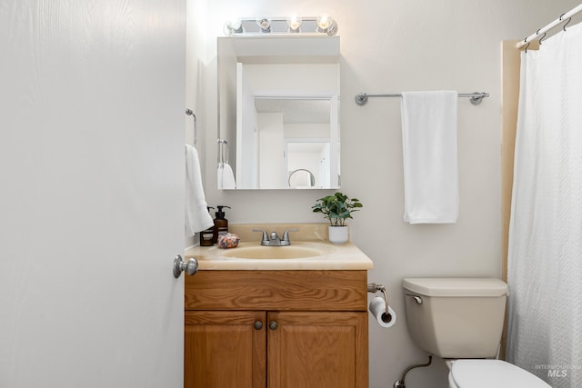 8305 W Rifleman St, Boise, ID 83704 - full bathroom featuring vanity, toilet, and a shower with shower curtain