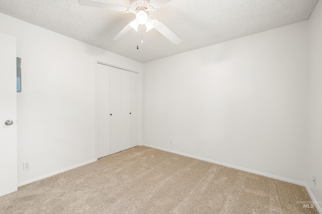 8305 W Rifleman St, Boise, ID 83704 - unfurnished bedroom featuring carpet flooring, a textured ceiling, a closet, baseboards, and a ceiling fan