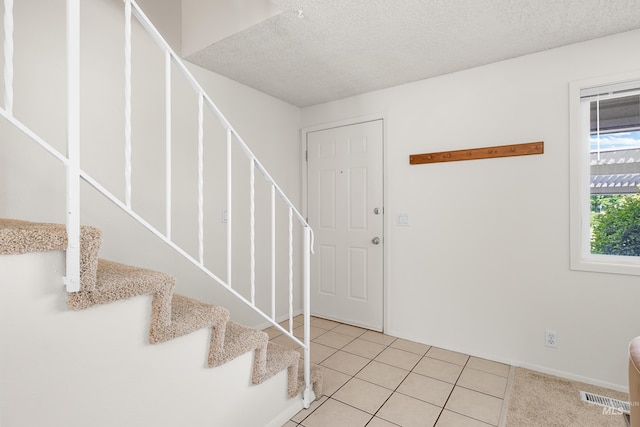 8305 W Rifleman St, Boise, ID 83704 - entrance foyer featuring stairway, a textured ceiling, and light tile patterned flooring