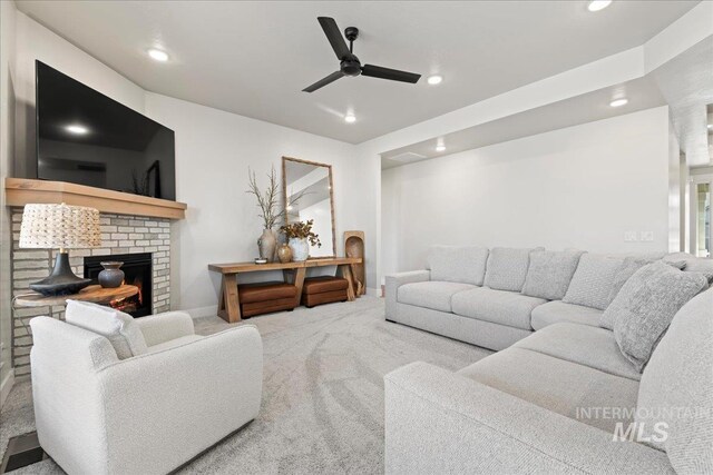 living room featuring ceiling fan, recessed lighting, a fireplace, baseboards, and carpet