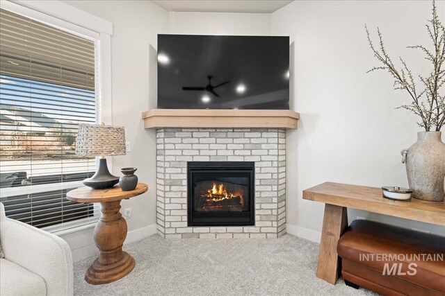 room details with carpet, a brick fireplace, and baseboards