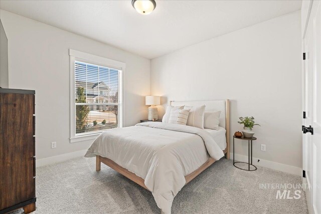 bedroom featuring carpet floors and baseboards