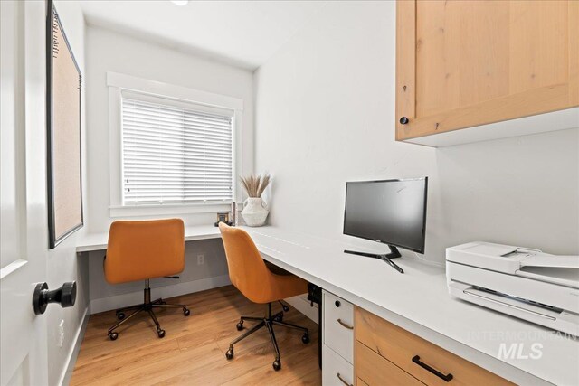 home office with light wood finished floors and baseboards