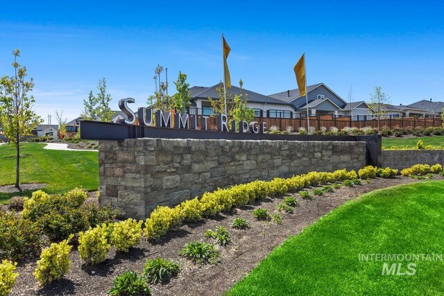 community sign with a yard, a residential view, and fence