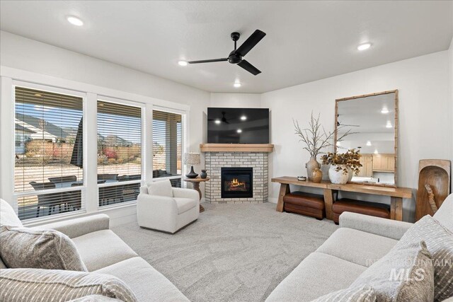 living area with a fireplace, carpet flooring, a ceiling fan, and recessed lighting