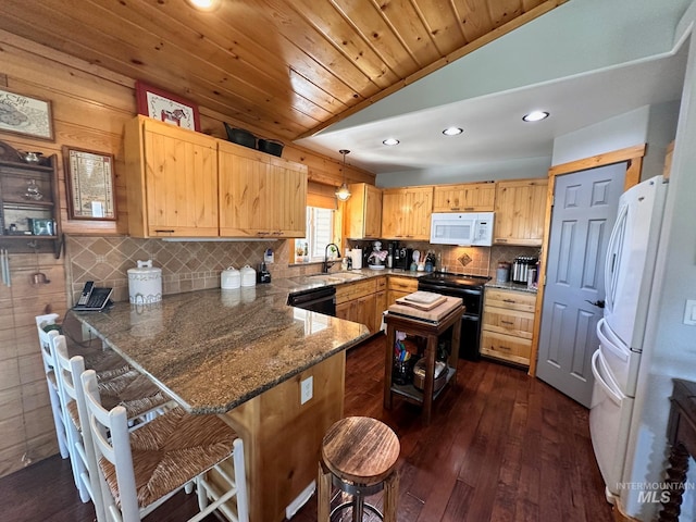 kitchen with a breakfast bar, dark hardwood / wood-style flooring, white appliances, hanging light fixtures, and kitchen peninsula