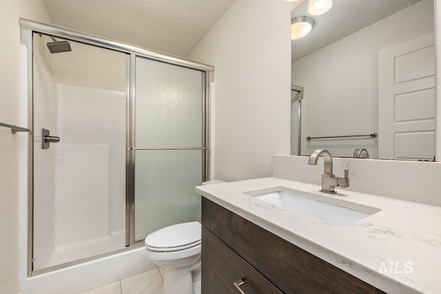 bathroom featuring a shower stall, toilet, vanity, marble finish floor, and a textured ceiling