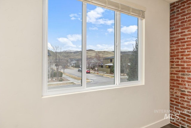 interior details with a residential view, a mountain view, and baseboards