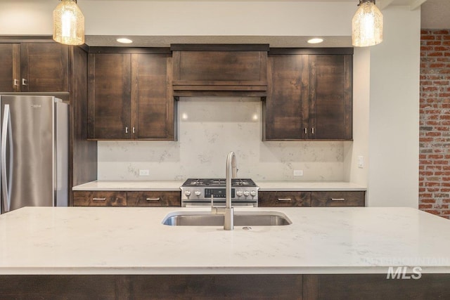 kitchen with pendant lighting, decorative backsplash, light stone countertops, and dark brown cabinets