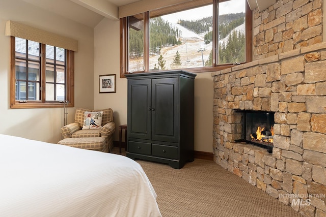 221 Picabo Street #D, Interest 1-H, Ketchum, ID 83340 - carpeted bedroom featuring a fireplace and beam ceiling