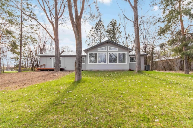 rear view of house with a yard, crawl space, and a wooden deck