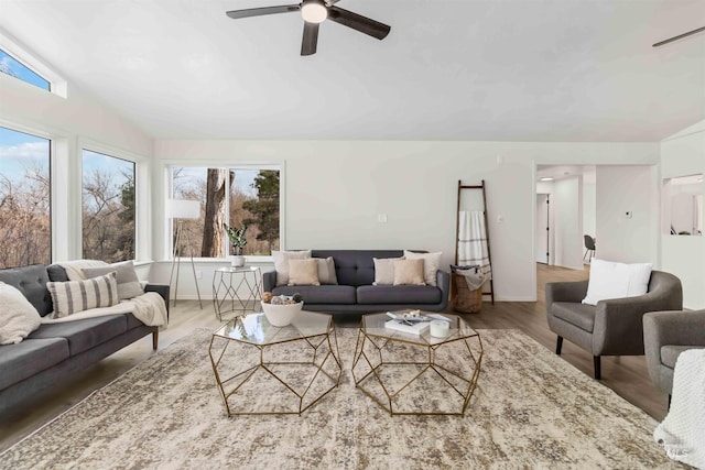 living room featuring visible vents, ceiling fan, wood finished floors, and lofted ceiling
