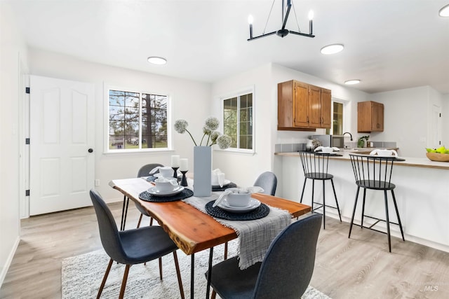 dining area with plenty of natural light, light wood finished floors, and baseboards
