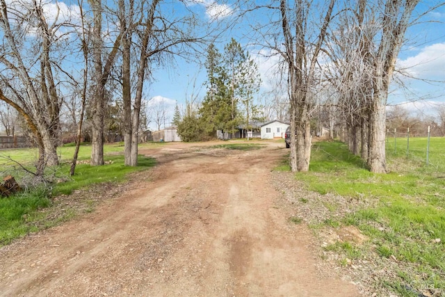 view of street featuring dirt driveway