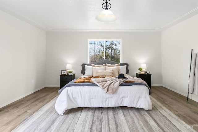 bedroom featuring baseboards and wood finished floors