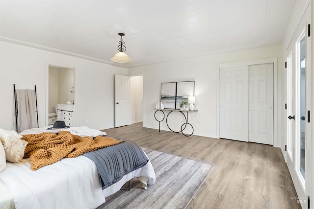 bedroom with wood finished floors and a closet