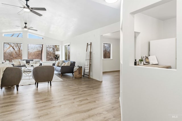 living area with wood finished floors, high vaulted ceiling, baseboards, and a ceiling fan