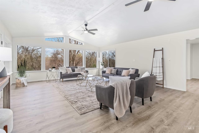 living room featuring wood finished floors, a ceiling fan, and lofted ceiling