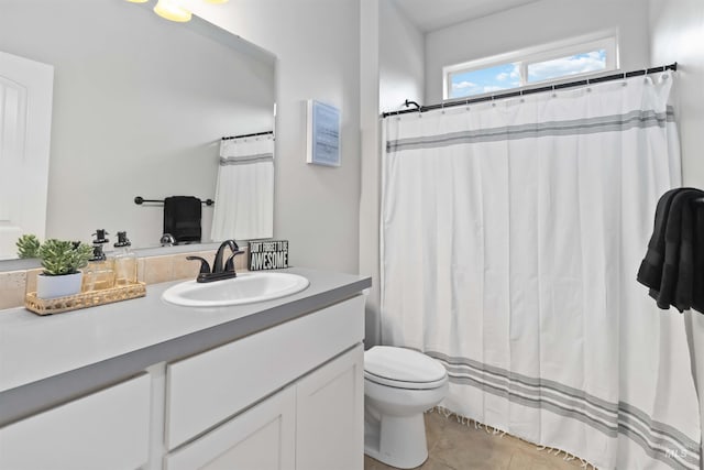 full bath featuring a shower with shower curtain, toilet, vanity, and tile patterned flooring