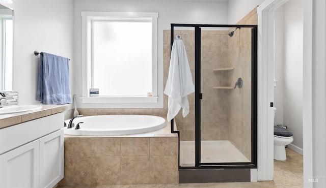 bathroom with vanity, a shower stall, a garden tub, and a healthy amount of sunlight