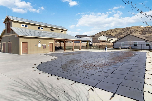 view of swimming pool with a patio area and fence