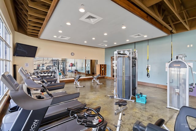 exercise room with recessed lighting, visible vents, and baseboards