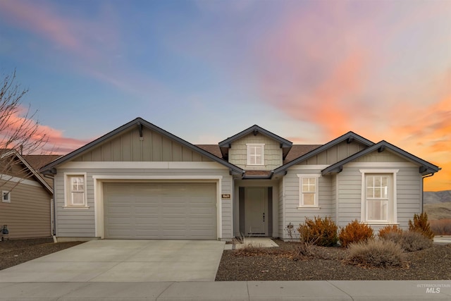 view of front of house with board and batten siding, concrete driveway, and a garage