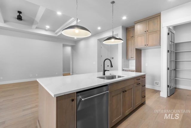 kitchen with pendant lighting, dishwasher, sink, a kitchen island with sink, and light hardwood / wood-style flooring