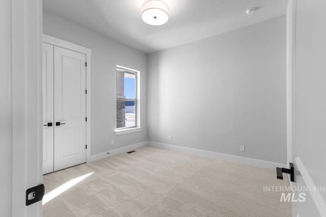 empty room with light colored carpet