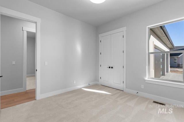 unfurnished bedroom with light carpet