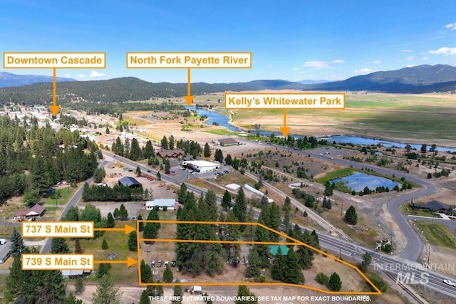 birds eye view of property featuring a water and mountain view