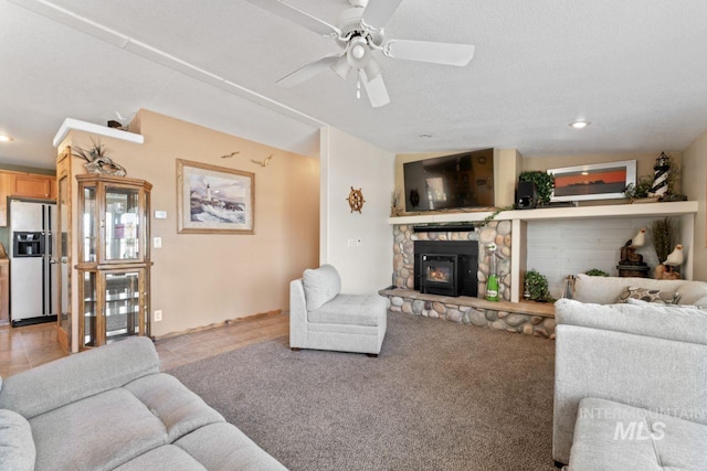 living room featuring recessed lighting, ceiling fan, light tile patterned floors, and a fireplace