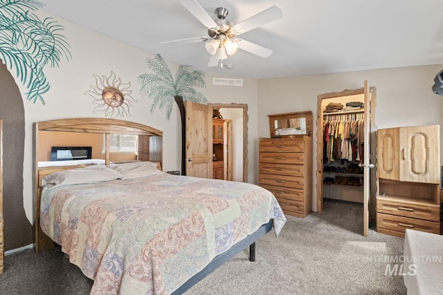 bedroom with carpet, a ceiling fan, a spacious closet, visible vents, and a closet
