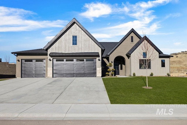 view of front of house featuring a garage and a front lawn