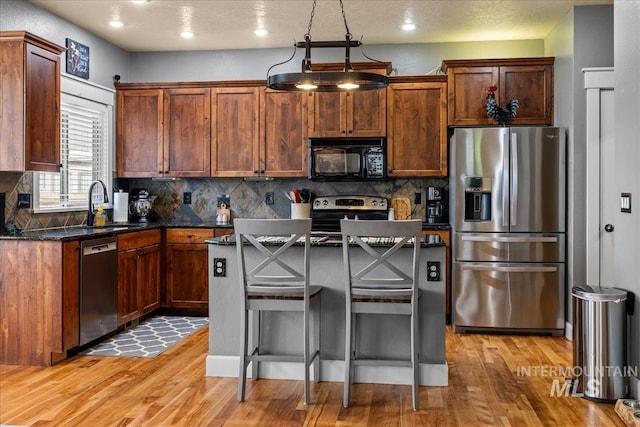1063 Hitchcock St, Meridian, ID 83646 - kitchen featuring backsplash, light wood finished floors, stainless steel appliances, and a sink