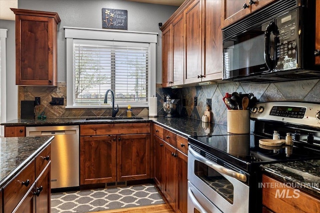 1063 Hitchcock St, Meridian, ID 83646 - kitchen featuring dark stone countertops, appliances with stainless steel finishes, tasteful backsplash, and a sink