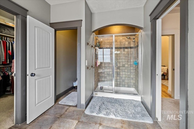 1063 Hitchcock St, Meridian, ID 83646 - bathroom featuring baseboards, a shower stall, and a walk in closet