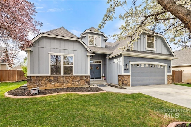 1063 Hitchcock St, Meridian, ID 83646 - craftsman-style house featuring driveway, stone siding, fence, board and batten siding, and a front yard