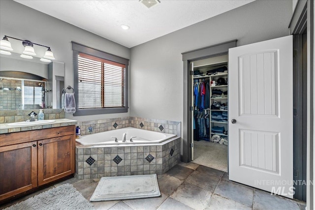 1063 Hitchcock St, Meridian, ID 83646 - bathroom featuring a stall shower, a bath, a walk in closet, vanity, and visible vents