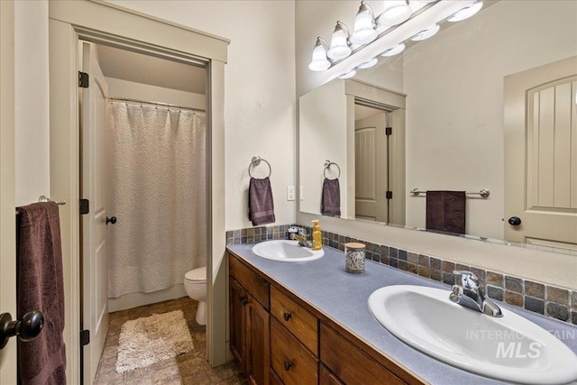 1063 Hitchcock St, Meridian, ID 83646 - bathroom featuring curtained shower, a sink, double vanity, and toilet
