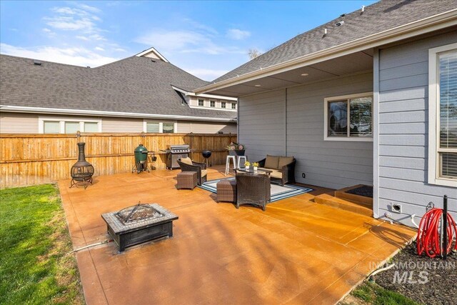 1063 Hitchcock St, Meridian, ID 83646 - view of patio with a fire pit, a grill, and fence