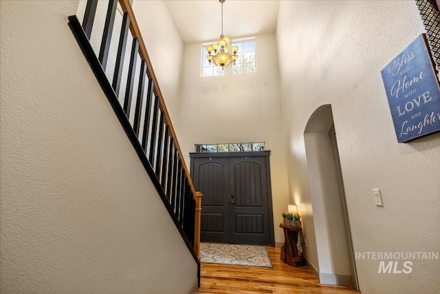 1063 Hitchcock St, Meridian, ID 83646 - foyer featuring a chandelier, wood finished floors, a wealth of natural light, and stairs