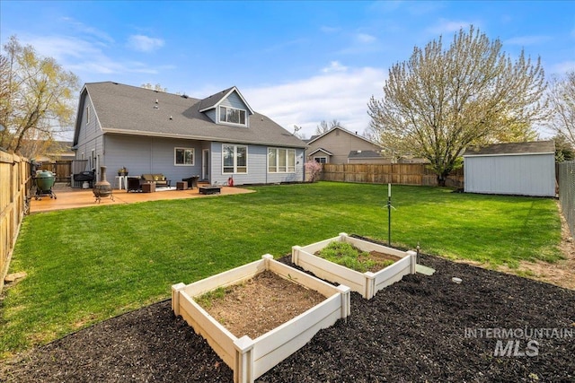 1063 Hitchcock St, Meridian, ID 83646 - back of house with a fenced backyard, a garden, an outbuilding, and a shed