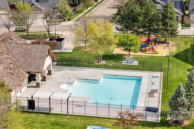 1063 Hitchcock St, Meridian, ID 83646 - pool featuring a patio area, a lawn, fence, and playground community