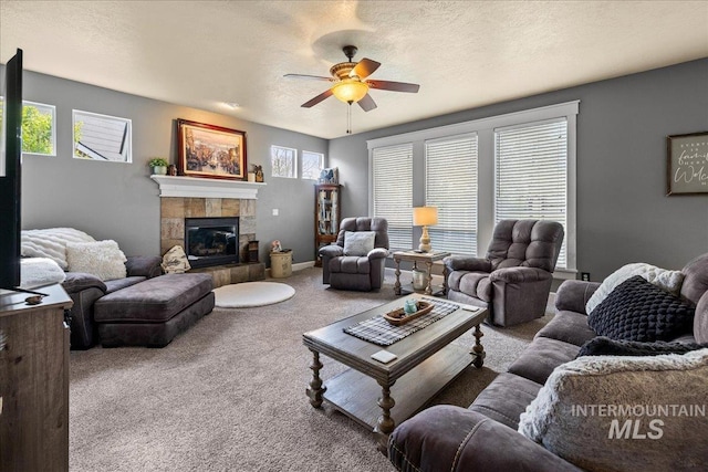 1063 Hitchcock St, Meridian, ID 83646 - carpeted living room with a tile fireplace and ceiling fan