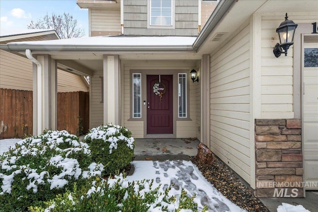 view of snow covered property entrance