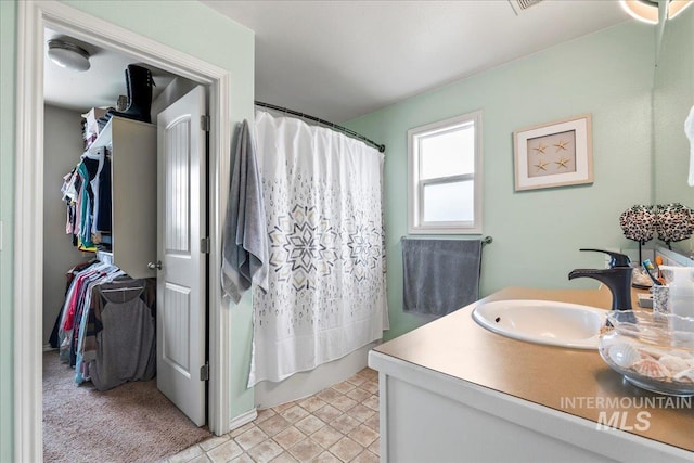 bathroom featuring shower / bath combination with curtain, tile patterned floors, and vanity