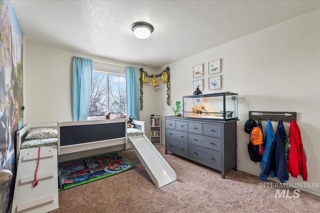 carpeted bedroom featuring a textured ceiling