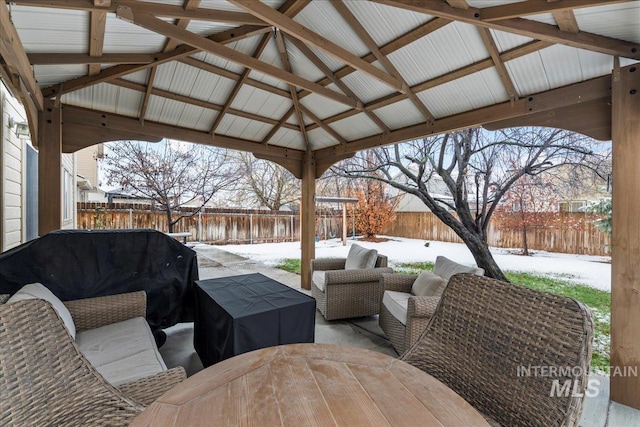 snow covered patio featuring an outdoor living space and a gazebo